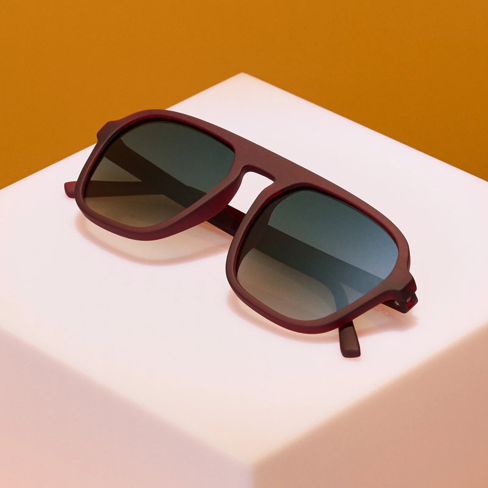 Brown retro style sunglasses with green gradient lenses.