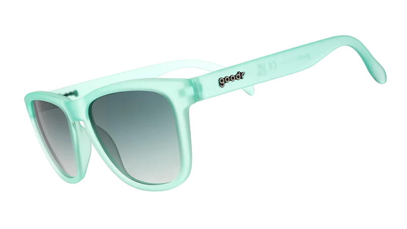 Product shot of mint green square-shaped sunglasses with gradient lenses.