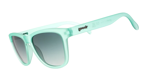 Product shot of mint green square-shaped sunglasses with gradient lenses.