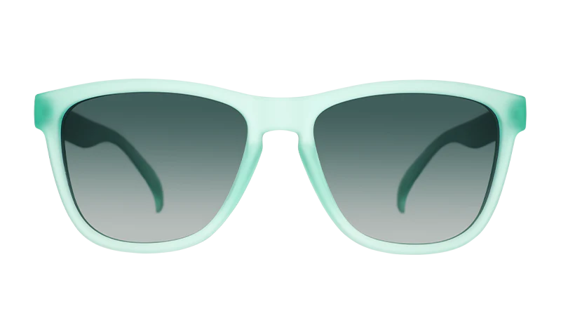 Product shot of mint green square-shaped sunglasses with gradient lenses.