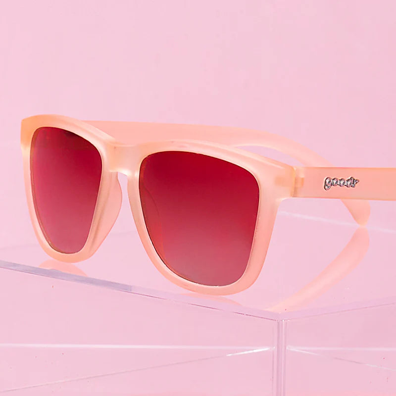 Pink square-shaped sunglasses with pink gradient lenses. 