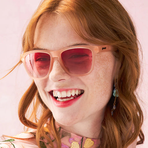 Style and fit showcase of pink square-shaped sunglasses with pink gradient lenses. Example of women's fit.