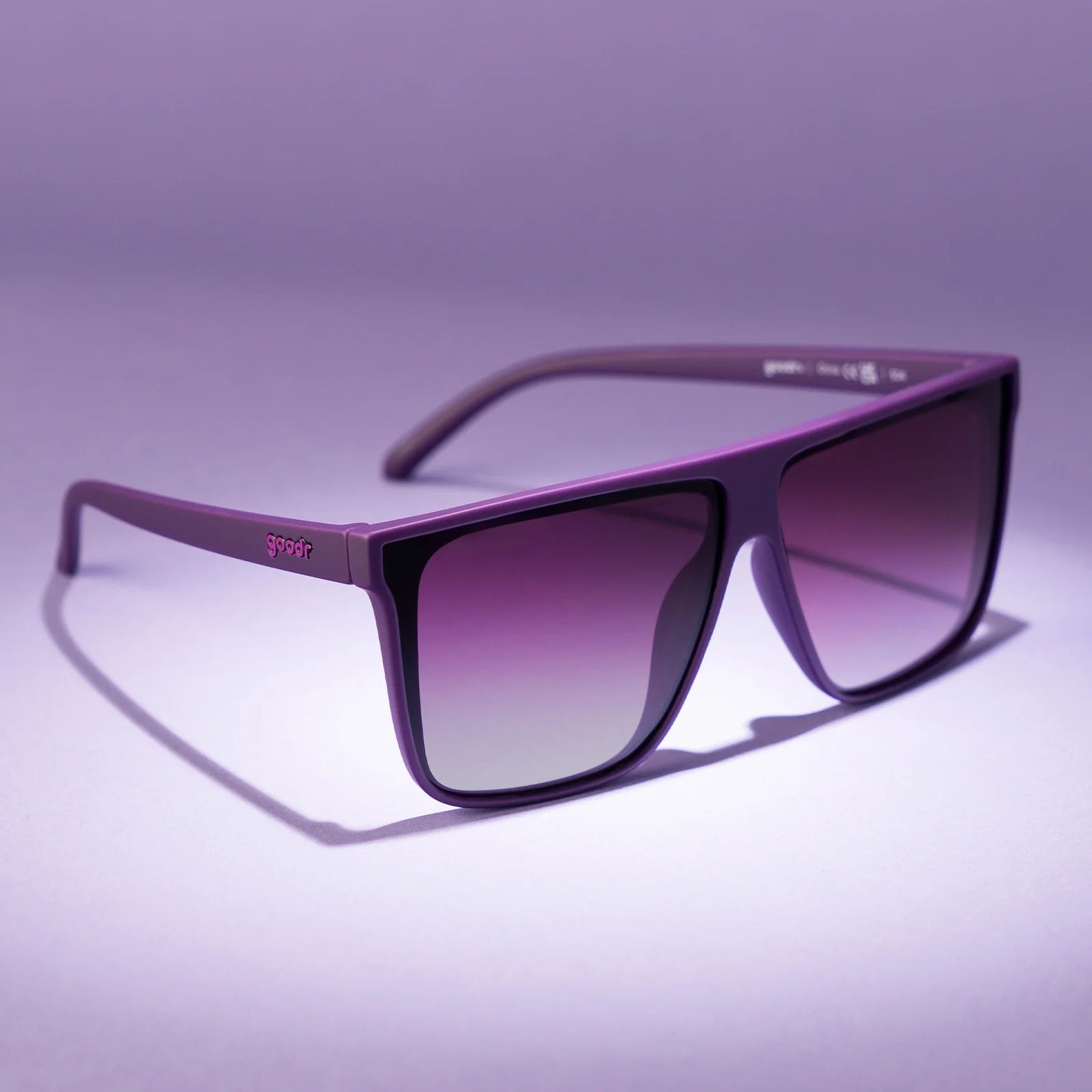 Oversized flat-top dark purple sunglasses with gradient lenses.
