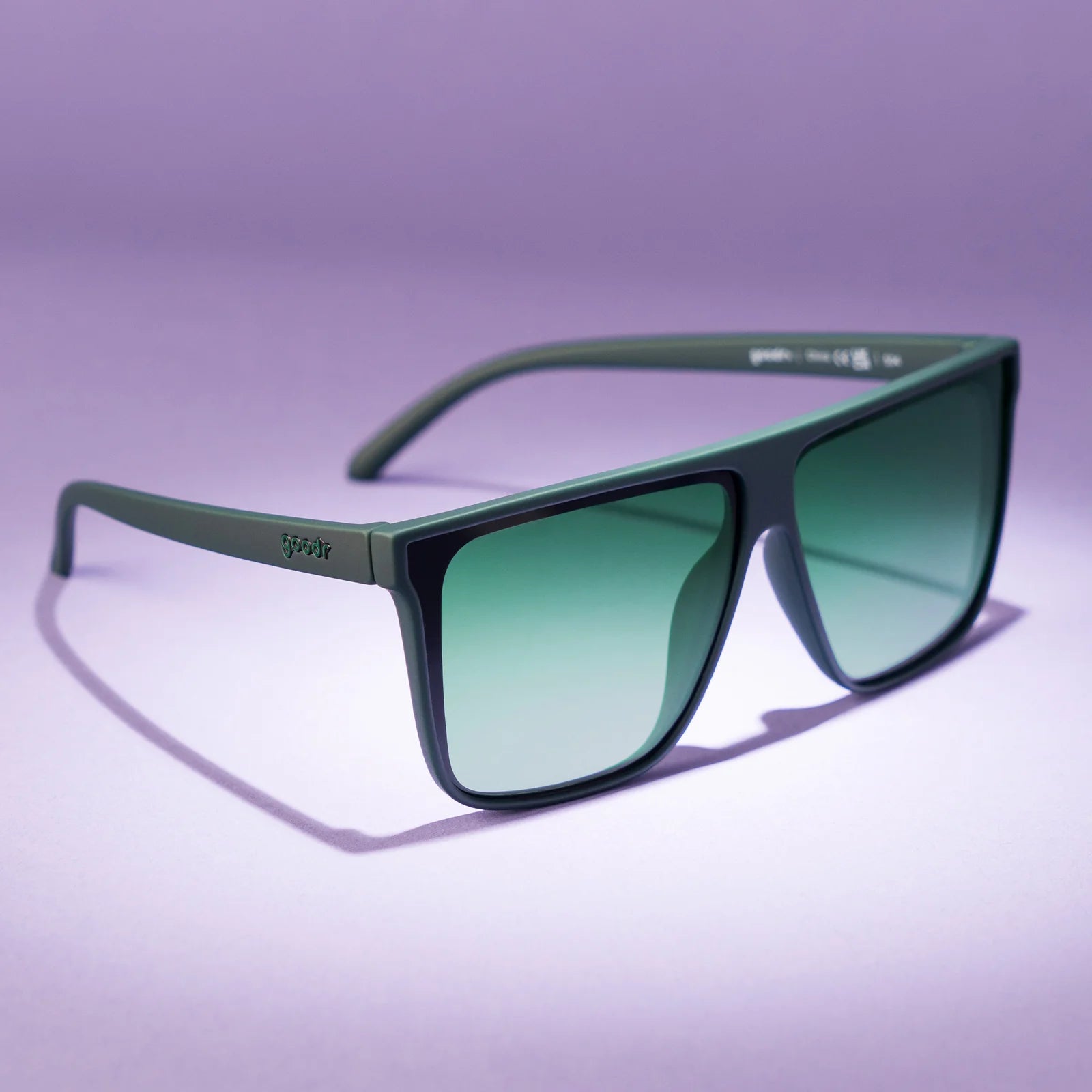 Dark green oversized flat-top sunglasses with gradient lenses for better ground visibility.