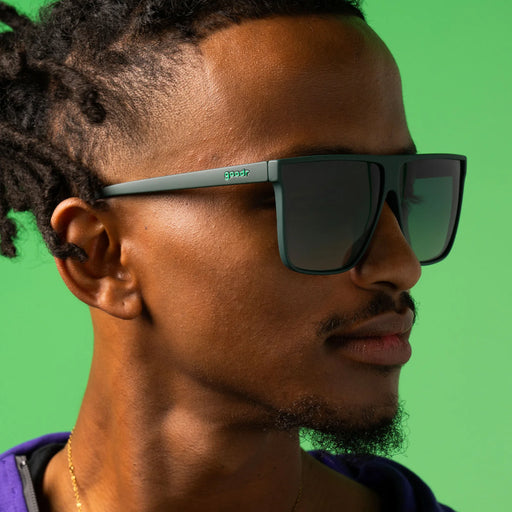 Style and fit showcase of dark green oversized flat-top sunglasses with gradient lenses for better ground visibility.
